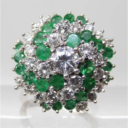 675 - AN 18CT GOLD EMERALD AND DIAMOND CLUSTER RING