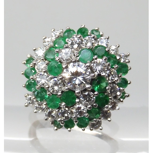 675 - AN 18CT GOLD EMERALD AND DIAMOND CLUSTER RING