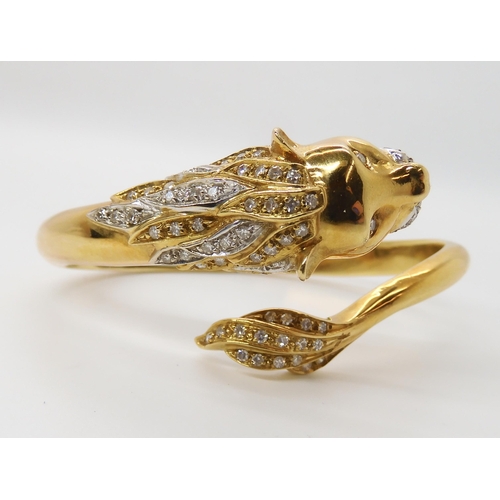 676 - AN 18CT GOLD AND DIAMOND HINGED LION BANGLE