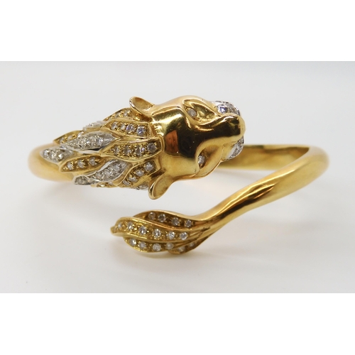 676 - AN 18CT GOLD AND DIAMOND HINGED LION BANGLE