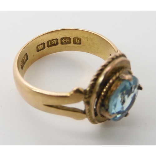 703 - AN 18CT GOLD BLUE GEM SET RING