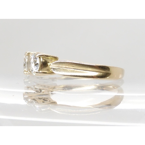 706 - AN 18CT YELLOW GOLD THREE STONE DIAMOND RING