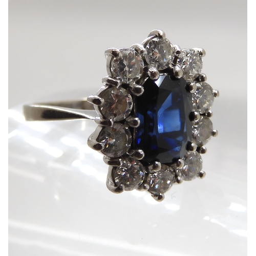 709 - AN 18CT WHITE GOLD SAPPHIRE AND DIAMOND CLUSTER RING