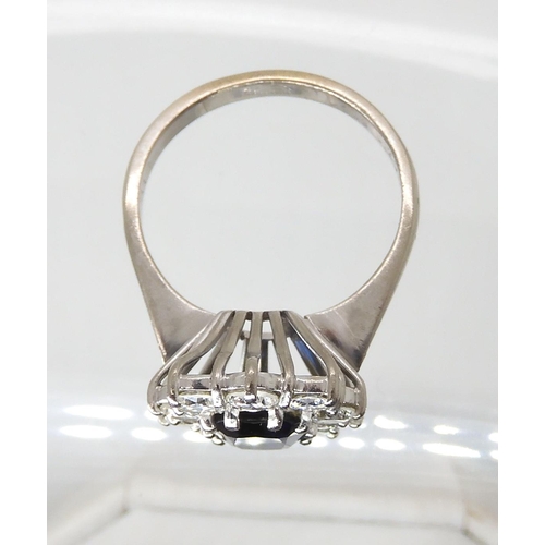 709 - AN 18CT WHITE GOLD SAPPHIRE AND DIAMOND CLUSTER RING