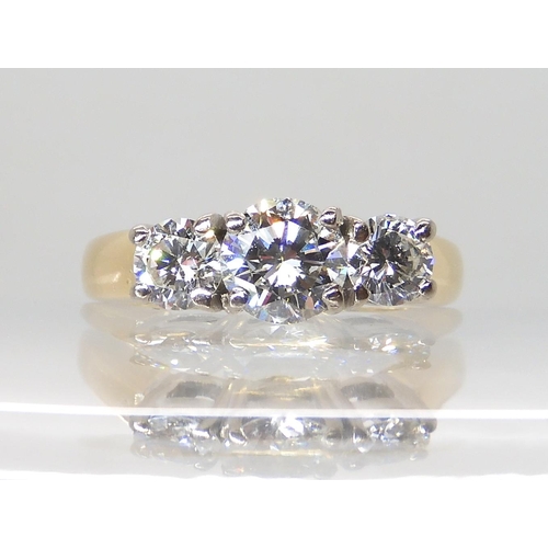 711 - AN 18CT GOLD THREE STONE DIAMOND RING