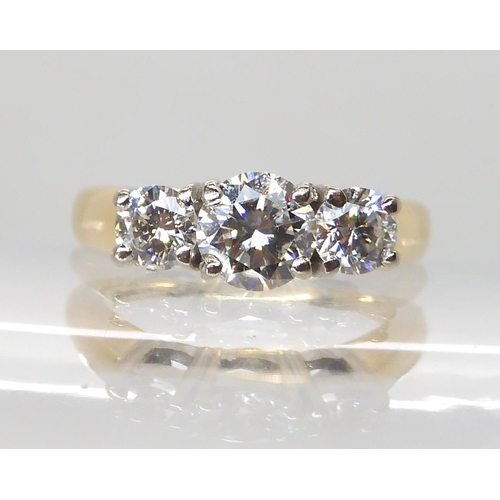 711 - AN 18CT GOLD THREE STONE DIAMOND RING