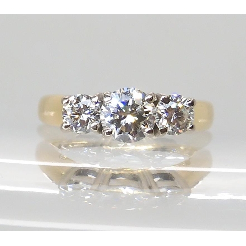 711 - AN 18CT GOLD THREE STONE DIAMOND RING