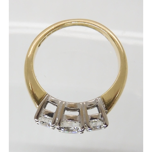 711 - AN 18CT GOLD THREE STONE DIAMOND RING