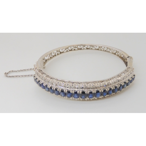 714 - AN 18K WHITE GOLD SAPPHIRE AND DIAMOND BANGLE