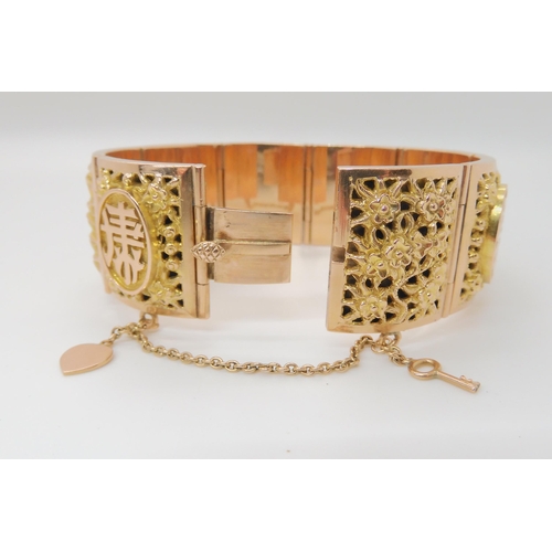 715 - A 14K GOLD CHINESE BANGLE