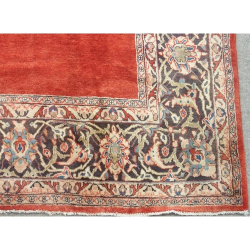 100 - A RED GROUND SAROUGH RUG