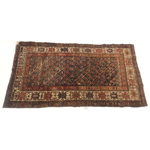 109 - A RED GROUND CAUCASIAN RUG