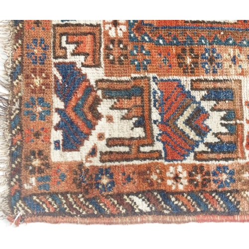 109 - A RED GROUND CAUCASIAN RUG