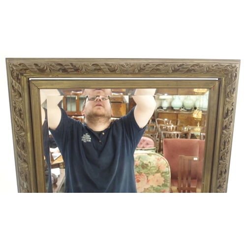 125 - A LARGE BRASS FRAMED CHEVAL TWO SIDED MIRROR