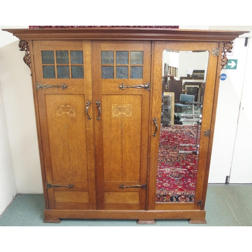 23A - AN EARLY 20TH CENTURY OAK ARTS AND CRAFTS TRIPLE DOOR WARDROBE