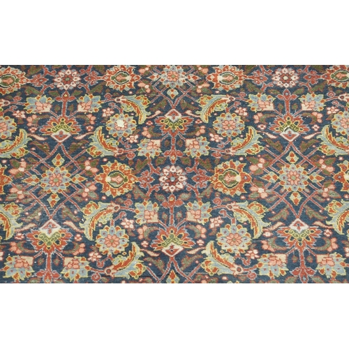 89 - A BLUE GROUND EASTERN RUG WITH ALLOVER FLORAL DESIGN