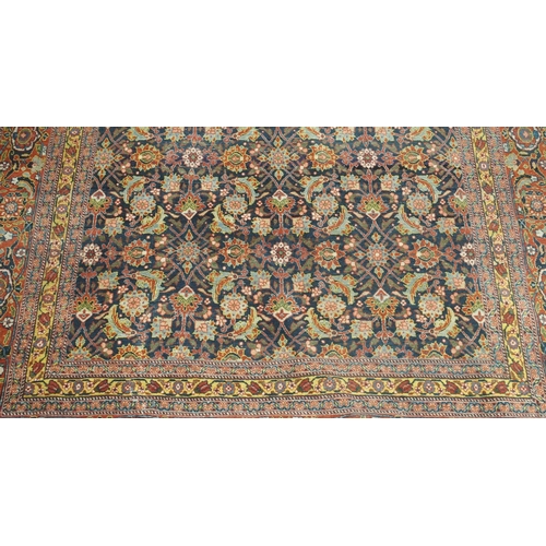 89 - A BLUE GROUND EASTERN RUG WITH ALLOVER FLORAL DESIGN