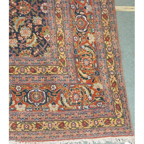 89 - A BLUE GROUND EASTERN RUG WITH ALLOVER FLORAL DESIGN