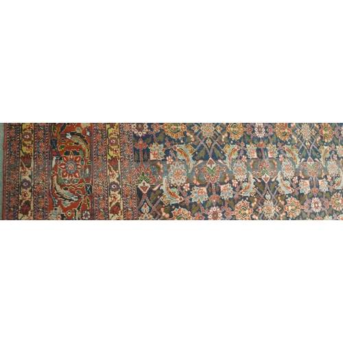 89 - A BLUE GROUND EASTERN RUG WITH ALLOVER FLORAL DESIGN