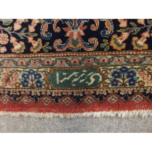 90 - A RED GROUND KESHAN RUG WITH BLUE CENTRAL MEDALLION AND MATCHING BORDER