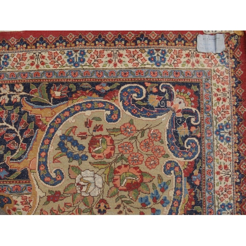 90 - A RED GROUND KESHAN RUG WITH BLUE CENTRAL MEDALLION AND MATCHING BORDER