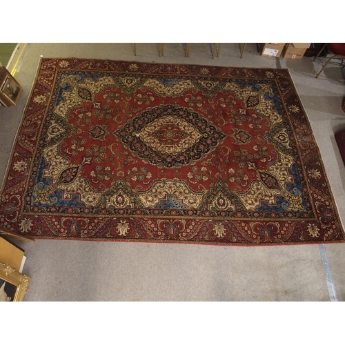 91 - A RED GROUND VINTAGE PERSIAN TABRIZ RUG WITH BLUE CENTRAL MEDALLION