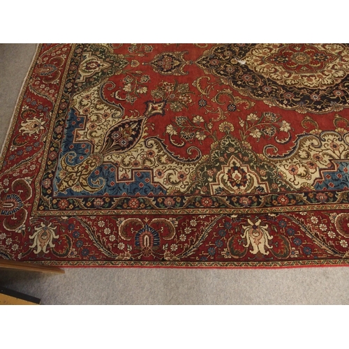 91 - A RED GROUND VINTAGE PERSIAN TABRIZ RUG WITH BLUE CENTRAL MEDALLION