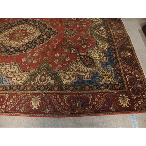 91 - A RED GROUND VINTAGE PERSIAN TABRIZ RUG WITH BLUE CENTRAL MEDALLION