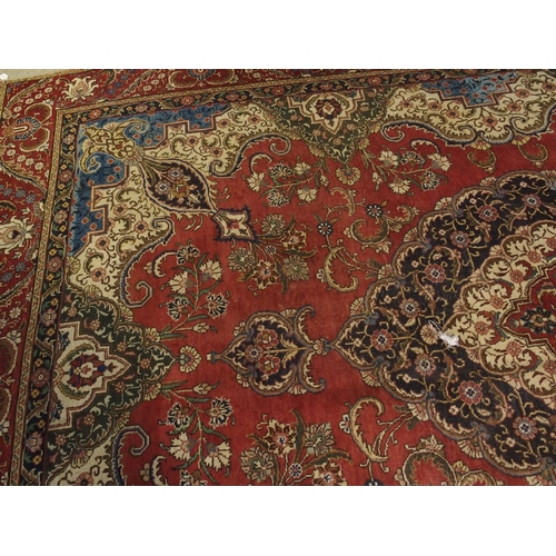 91 - A RED GROUND VINTAGE PERSIAN TABRIZ RUG WITH BLUE CENTRAL MEDALLION