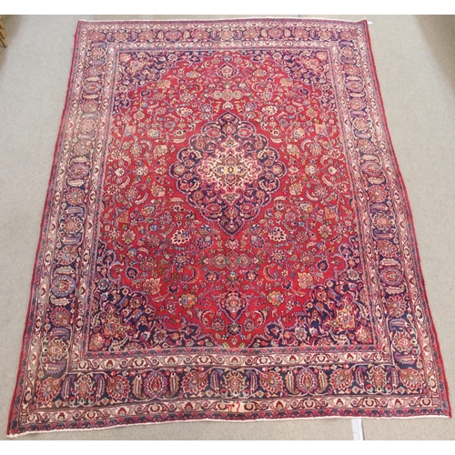 92 - A RED GROUND MESHED RUG