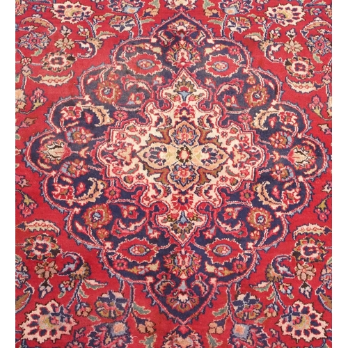 92 - A RED GROUND MESHED RUG