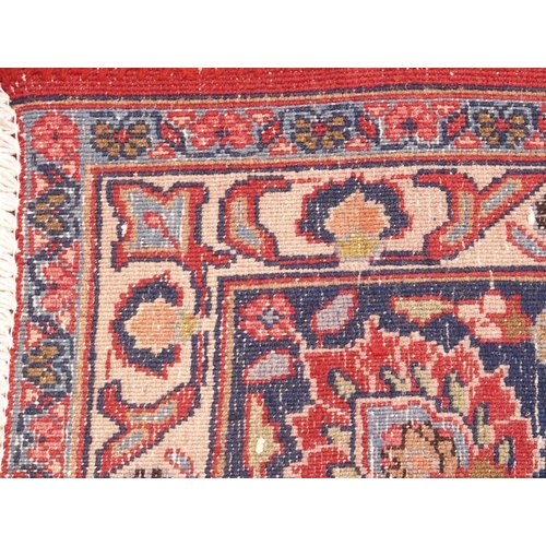 92 - A RED GROUND MESHED RUG