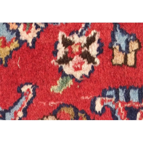 92 - A RED GROUND MESHED RUG