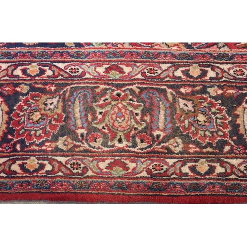 92 - A RED GROUND MESHED RUG