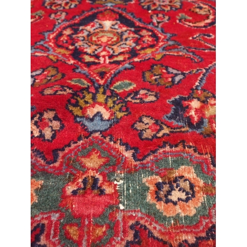 92 - A RED GROUND MESHED RUG