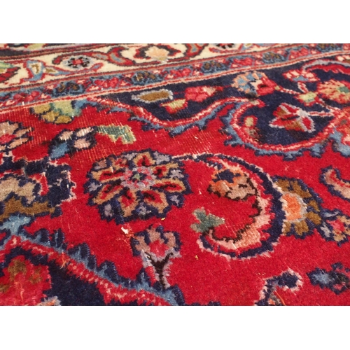 92 - A RED GROUND MESHED RUG