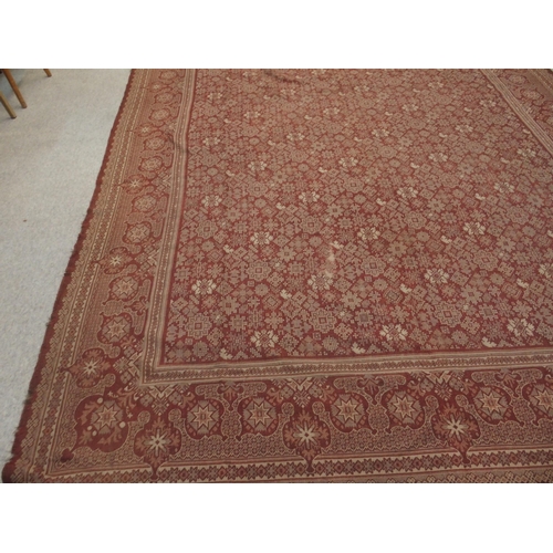 94 - A LARGE RED GROUND RUG WITH GEOMETRIC DESIGN