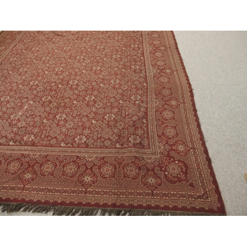 94 - A LARGE RED GROUND RUG WITH GEOMETRIC DESIGN