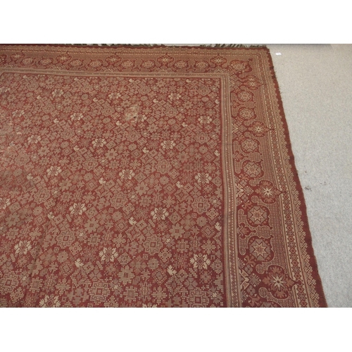 94 - A LARGE RED GROUND RUG WITH GEOMETRIC DESIGN