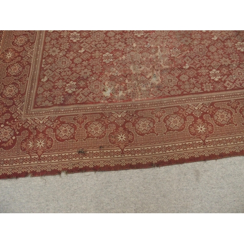 94 - A LARGE RED GROUND RUG WITH GEOMETRIC DESIGN