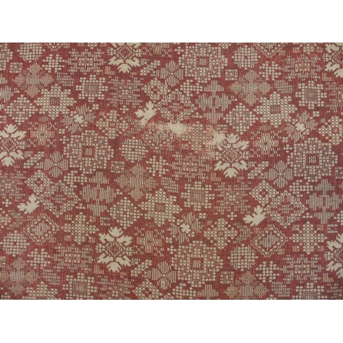 94 - A LARGE RED GROUND RUG WITH GEOMETRIC DESIGN