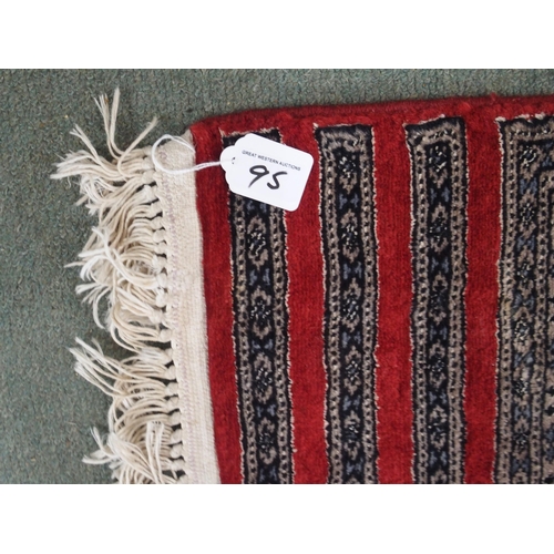 95 - AN EASTERN RUG WITH FOUR MAIN RED PANELS