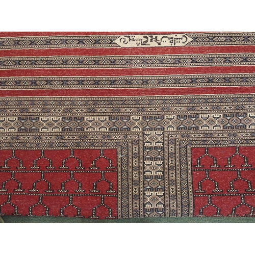 95 - AN EASTERN RUG WITH FOUR MAIN RED PANELS