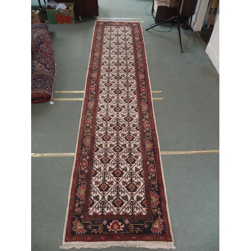 97 - A CREAM GROUND RUNNER WITH STYLISED FLOWERS