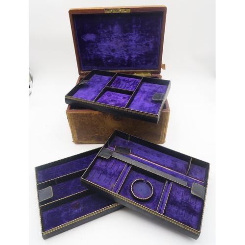 619A - A Victorian tooled leather jewellery box by Carlisle & Watts, Edinburgh, with velvet-lined fitte... 