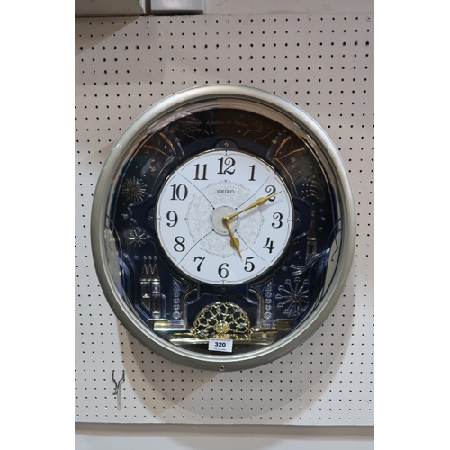 A Seiko Melodies in Motion musical battery wall clock QXM239S