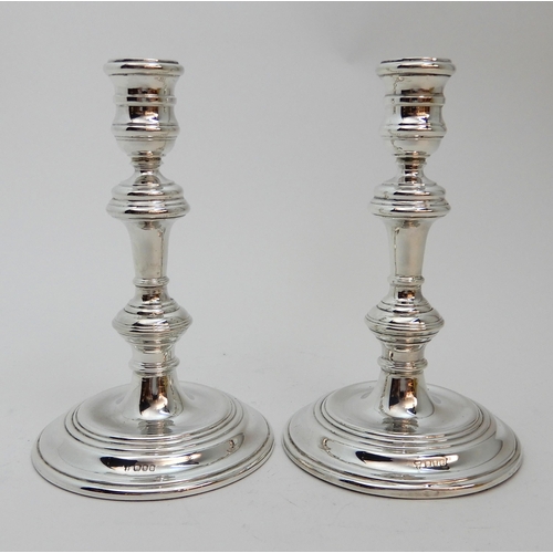 126 - A PAIR OF GEORGIAN STYLE SILVER CANDLESTICKS