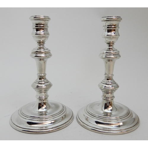 126 - A PAIR OF GEORGIAN STYLE SILVER CANDLESTICKS