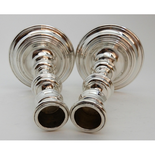 126 - A PAIR OF GEORGIAN STYLE SILVER CANDLESTICKS