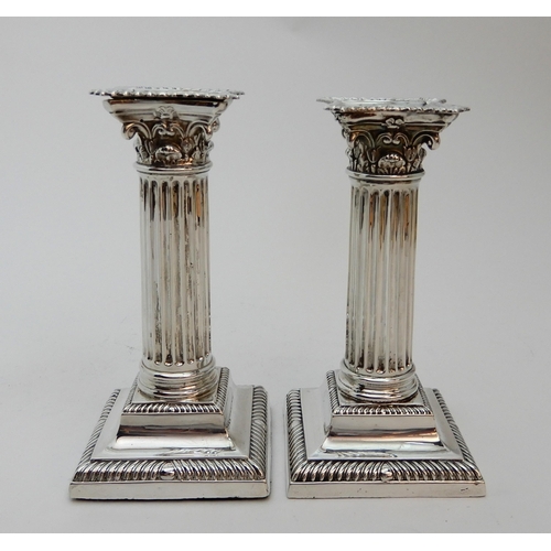 127 - A PAIR OF SILVER CANDLESTICKS